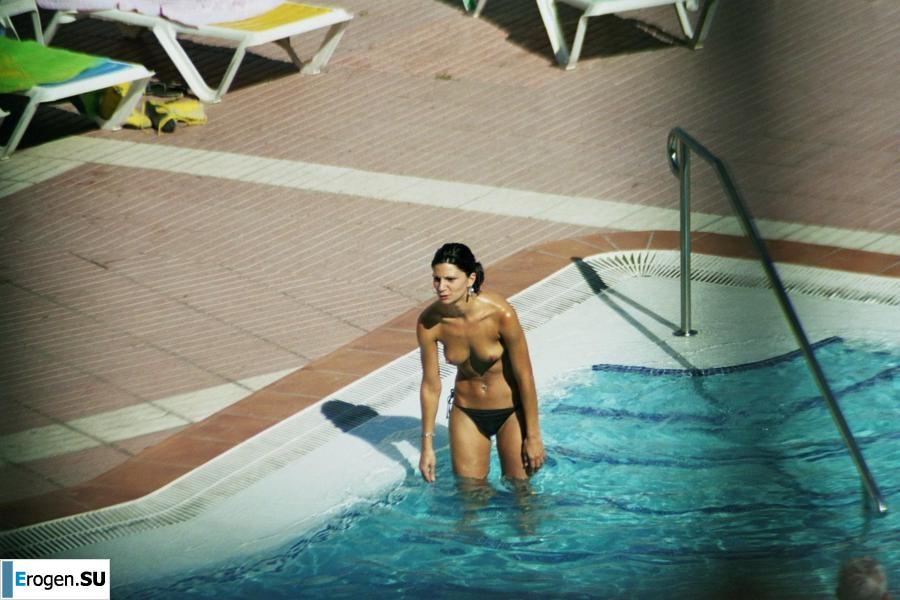Girls sunbathe topless near the pool. Photo 2