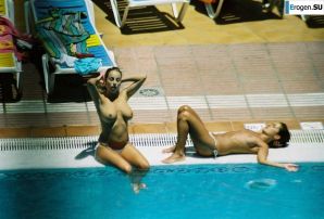 Girls sunbathe topless near the pool. Thumb 3