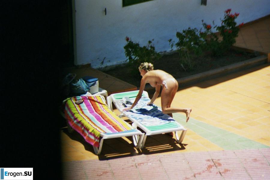 Girls sunbathe topless near the pool. Part 3. Photo 1
