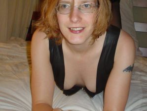 A red-haired student with glasses spread her legs in lace stockings and showed a pussy. Thumb 2