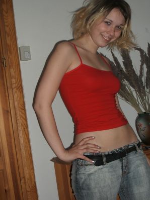 A blonde with a thin waist poses in glasses and red panties. Part 2. Thumb 1