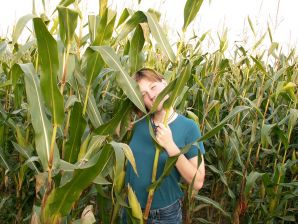 A thin student pleases herself with corn right in the field. Thumb 1